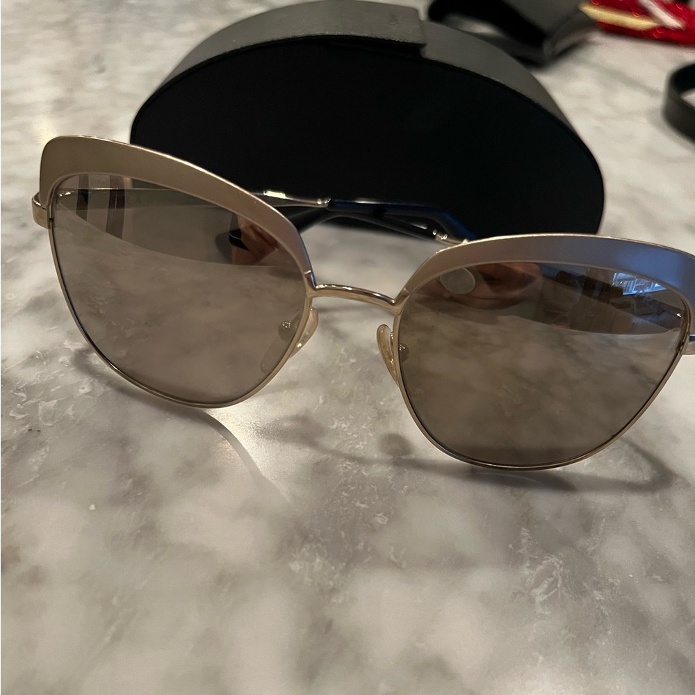 Gold Prada sunglasses. Worn a hand full of times
